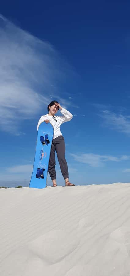 Cape Town: Atlantis Sand Dunes Sandboarding Experience - Sandboarding at Atlantis Dunes, with Table Mountain in view